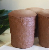 three chocolate pots sitting on top of a white plate